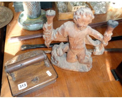 Carved wooden clockwork musical toilet roll holder and a lime wood carved figural candlestick