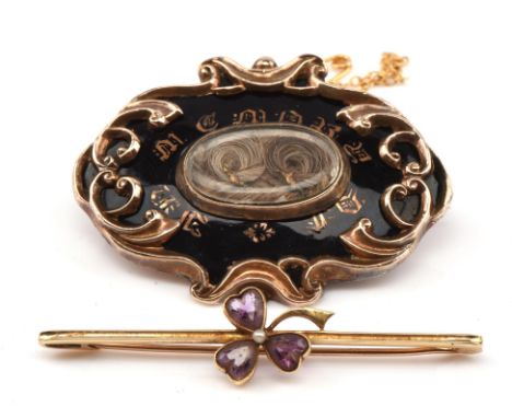 Victorian mourning brooch, with oval hairwork panel and enamel and foliate surround, safety chain, measures 44mm x 35mm, test