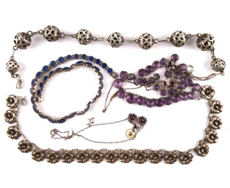 Five necklaces consisting of a flower motif necklace stamped Sterling silver, a lapis round panel necklace stamped 950, a yel