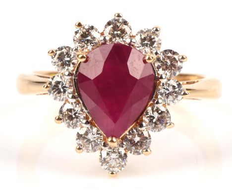 Ruby and Diamond ring, with a pear cut ruby surrounded by twelve round brilliant cut diamonds in a halo setting, certificated