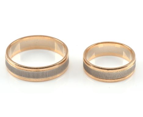 Two matching bi-colour wedding bands, designed with a white gold central band with an engine turned design, with plain polish
