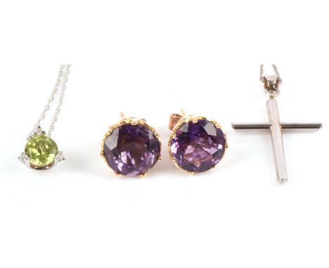 Three items including a peridot and diamond pendant with chain, in white metal stamped for 14 ct gold, a plain cross pendant 