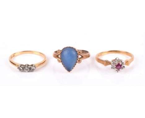 Three rings, one set with three graduated brilliant cut diamonds, central diamond estimated at 0.14 carat, ring size Q, a rub