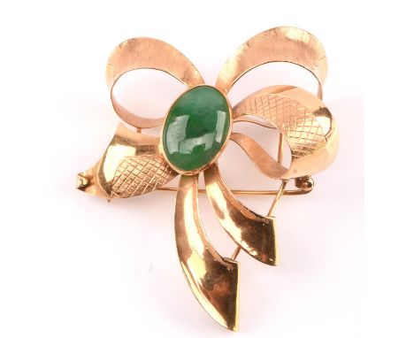 Bow brooch set with a cabochon cut jade, with textured gold ribbon, tested as 18 ct, measures 55 x 65mmCondition Report:  Gro