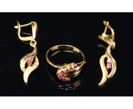 A pair of ruby drop earrings, each set with two round cut rubies, with a textured gold twist surrounded, with post and lever 