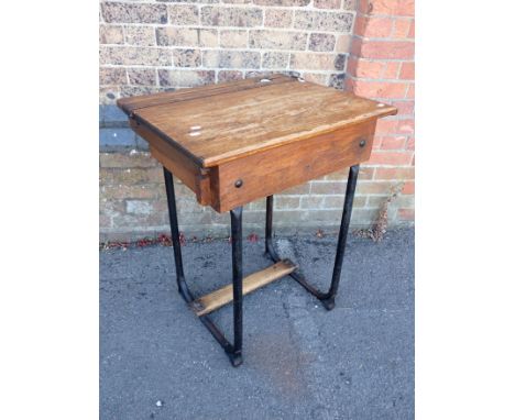 A VINTAGE OAK SCHOOL DESK on iron legs 64cm wide