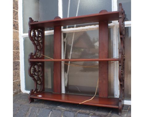 A MAHOGANY HANGING SHELF WITH FRETWORK SIDES 52.5cm wide