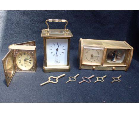 A BRASS CASED CARRIAGE ALARM CLOCK the enamel dial with alarm indicator, unnamed,15cm high, handle up (not running, alarm spr