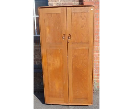 AN ERCOL BLOND ELM WARDROBE with blue label
