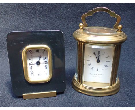 MATTHEW NORMAN, LONDON: OVAL-CASED CARRIAGE CLOCK TIMEPIECE 11cm high, handle up, (not running, and no key), and a Matthew No