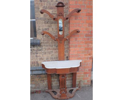 A VICTORIAN OAK HALLSTAND with arrangement of pegs and marble topped shelf 90cm wide