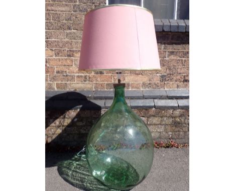 A LARGE GLASS CARBOY, FITTED AS A LAMP 