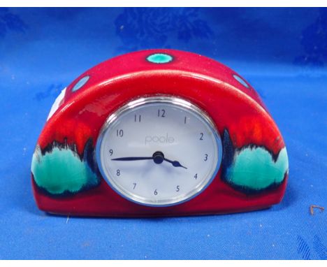 A DEMI-LUNE POOLE POTTERY CLOCK in Volcano pattern, 9 cms high
