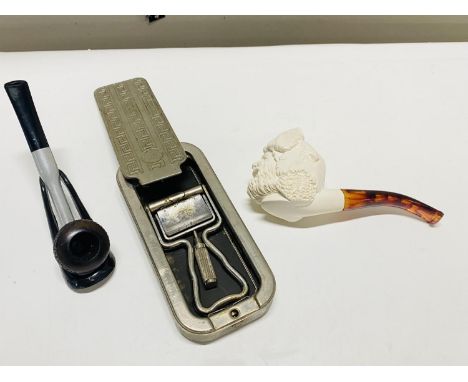 Two vintage pipes and a Rolls razor 