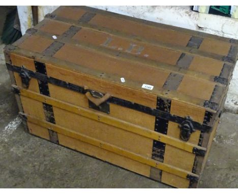 A Vintage steel and wood strep work bound travelling trunk, retailed by Parks of Eastbourne, width 87cm