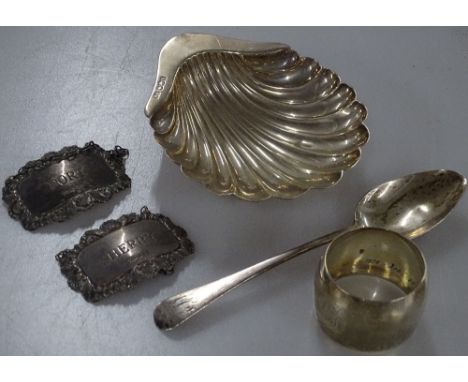 A silver shell design dish, a napkin ring, a spoon, and 2 silver decanter labels (5), 4.3oz