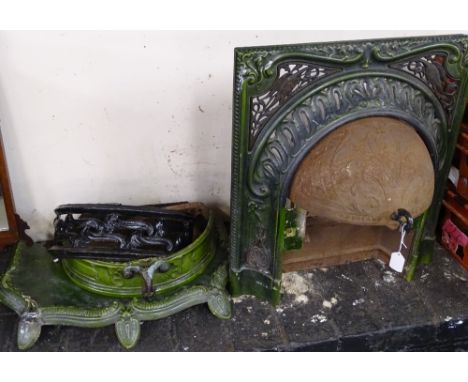 An Art Nouveau green enamel fireplace and grate