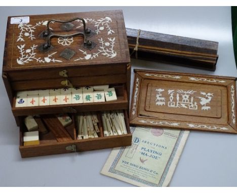 A Chinese early 20th century Mahjong set, early 20th century, in original ivory inlaid rosewood cabinet, width 9.5", together