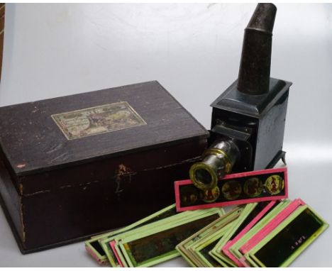 A 19th century tinplate nursery magic lantern, original pine case, with selection of slides