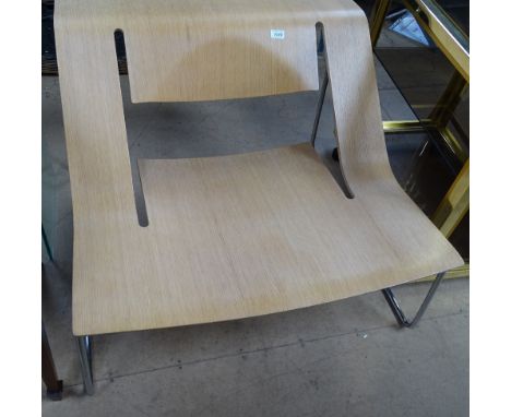 A contemporary stylish bent ply lounge chair, on chrome rod sled base