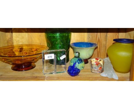 A shelf of decorative glass ware