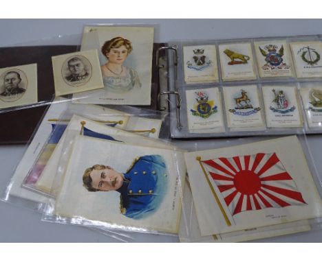 An album of silk cigarette cards and larger portrait silk cigarette cards