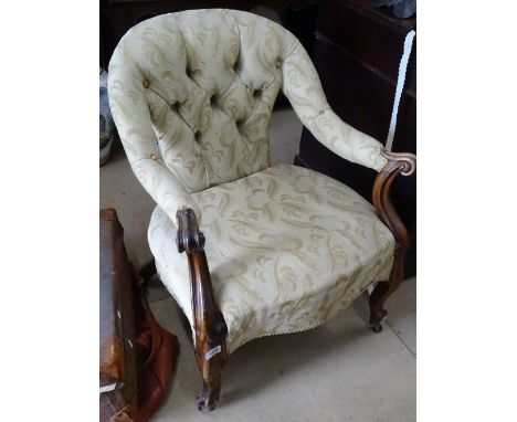 A Victorian button-back upholstered open armchair, on carved cabriole legs