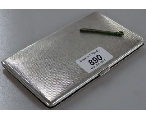 A rectangular, engine turned, sterling silver cigarette case, 5.9oz, and a green stone-set brooch