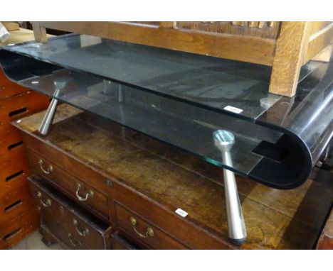 A contemporary clear and black glass rectangular bow-end coffee table on chrome legs, length 130cm