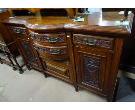 A late Victorian walnut bow-front sideboard, with carved drawer and cupboard fronts, length 153cm
