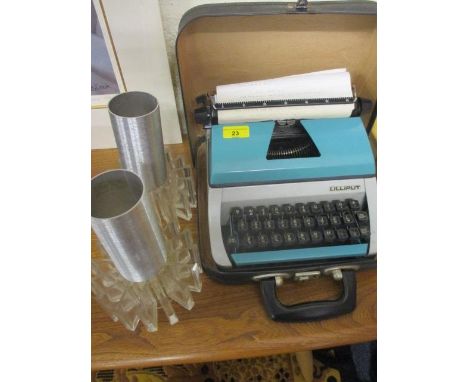 A retro Lilliput manual typewriter and a pair of contemporary clear plastic and aluminium light shades 