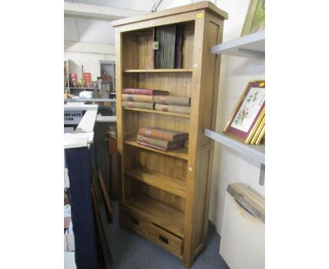 A modern light oak bookcase having fitted shelves and two short drawers 74 3/4"h x 35"w 