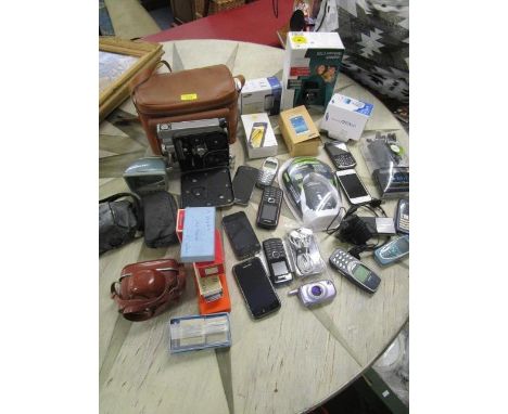 A mixed lot of cameras and mobile phones to include an Admica 8F cine camera, Samsung, Nokia mobile phones and others 