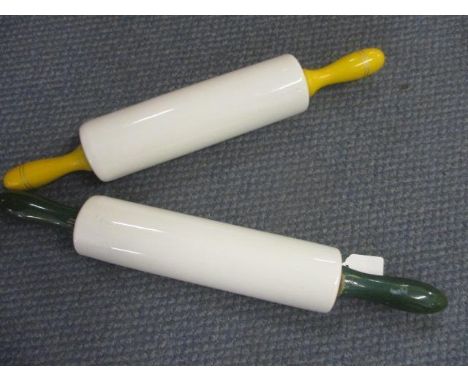 A vintage T G Green ceramic rolling pin with green wooden handles and a vintage Nuitbrown ceramic rolling pin with yellow woo