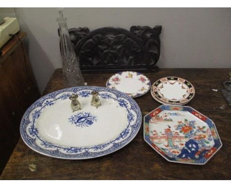 A mixed lot to include a pair of silver pepper pots, a glass decanter, various plates and a carved wooden panel 