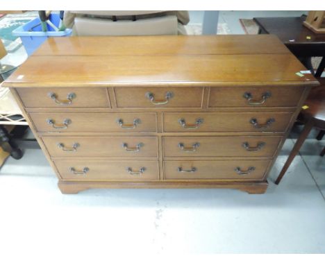 A reproduction light mahogany bedding box / tv cabinet modelled as chest of three over 6 drawers, approx. dimensions W25 H 74