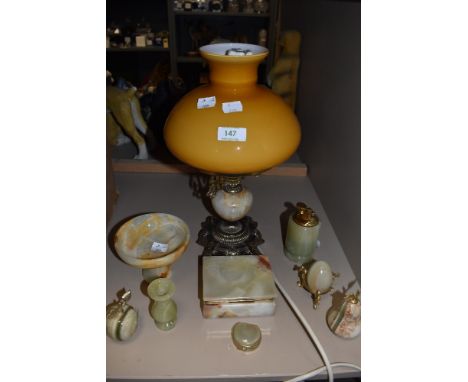 A collection of decorative onyx items, including lamp with ochre glass shade, trinket and pill boxes, desk top lighter and si