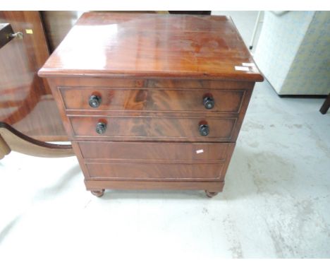 A 19th century mahogany commode formed as small chest of drawers, with lift top and fitted interior, on turned feet, approx. 