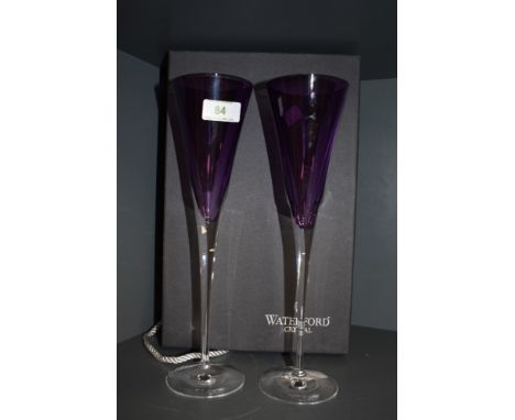 A pair of amethyst coloured Waterford crystal flutes, with box. 