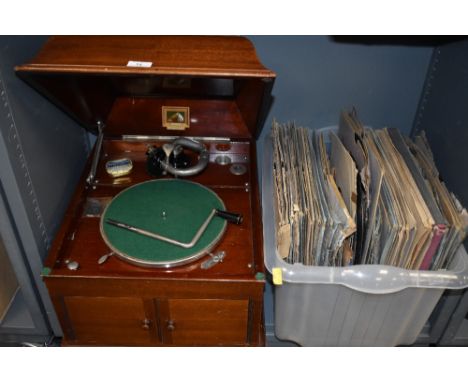 A HMV wooden cased wind up gramophone, model 103, also included are a tin of needles and a box of 78s, in good working order.