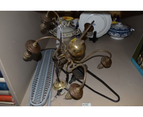 A centre light fitting in brass and similar.
