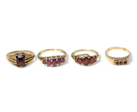 A 9 carat gold ruby ring and three 9 carat gold garnet rings (4) Ruby ring - Finger size U, 3.44g gross. Three garnet rings -