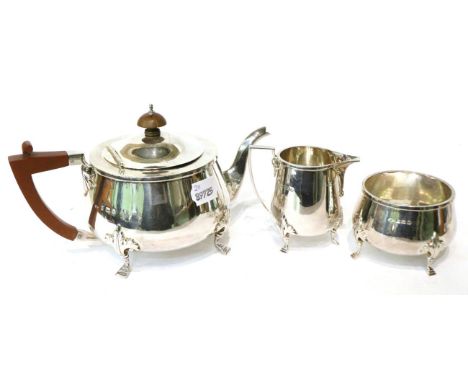 A three piece silver tea service, Adie Bros, Birmingham 1923, with foliate capped stepped hoof feet, teapot 13cm high, 29.5oz