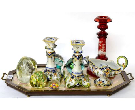 A red flashed and engraved glass candlestick with deer in a wooded landscape; a pair of French faience candlesticks and chamb