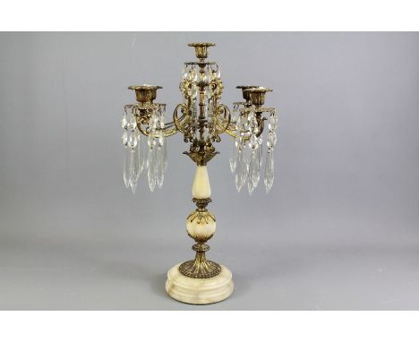 A Marble and Brass Table Candelabra. The candelabra has four candle points each with five glass prisms and a central candle p