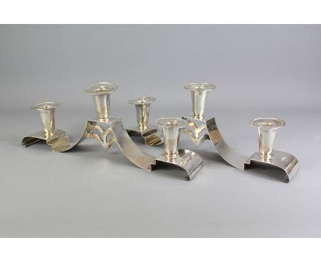 A Pair of Post War Modernist Silver Candlestick Holders. The candlestick holders have cradles for three candles, approx 38 cm