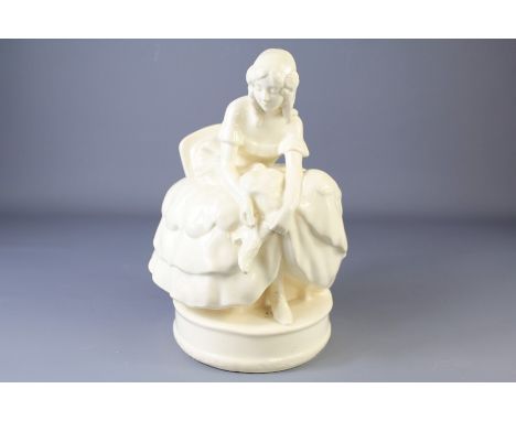 A German 'Goldscheider' Porcelain Lady Figurine. The figure depicted seated tying her laces, approx 30 cms together with a se