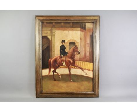 An Early 20th Century Oil on Canvas. Portrait of a woman riding aside in the dressage ring, approx 59 x 79 cms, signed lower 