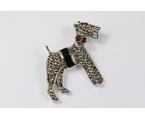 A Silver and Marcasite Brooch of an Airedale Terrier. The brooch having a ruby collar, approx 33 x 33 mm.