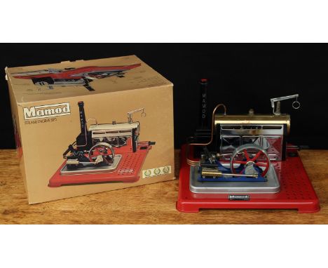 A Mamod SP5 live steam stationary engine, single red spoked cylinder with control lever, single black chimney, polished brass